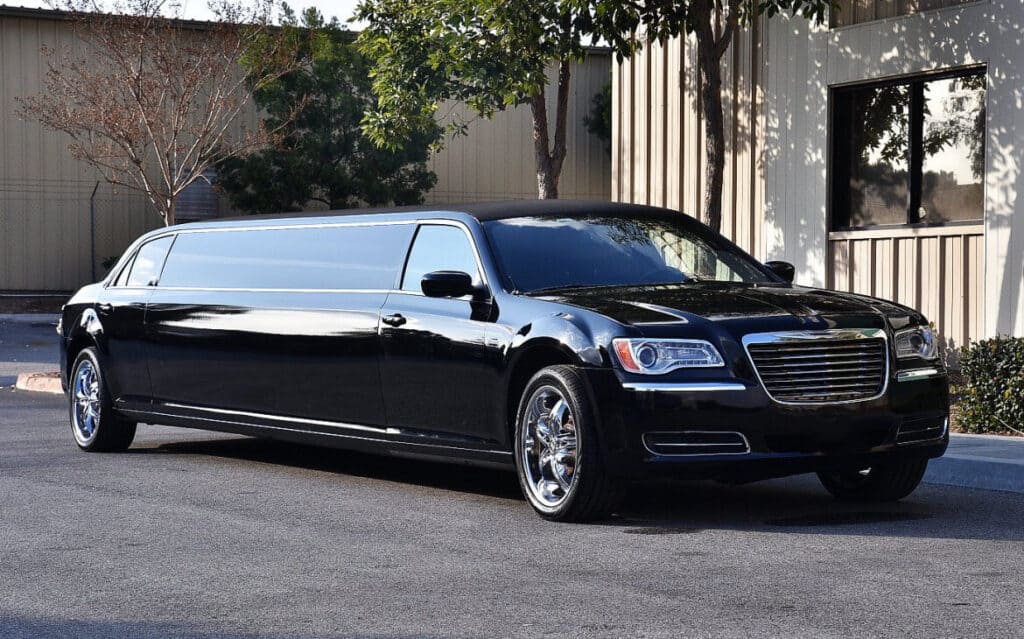 A black limo parked on the side of the road.