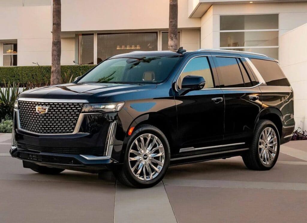 A black suv parked on the side of a road.