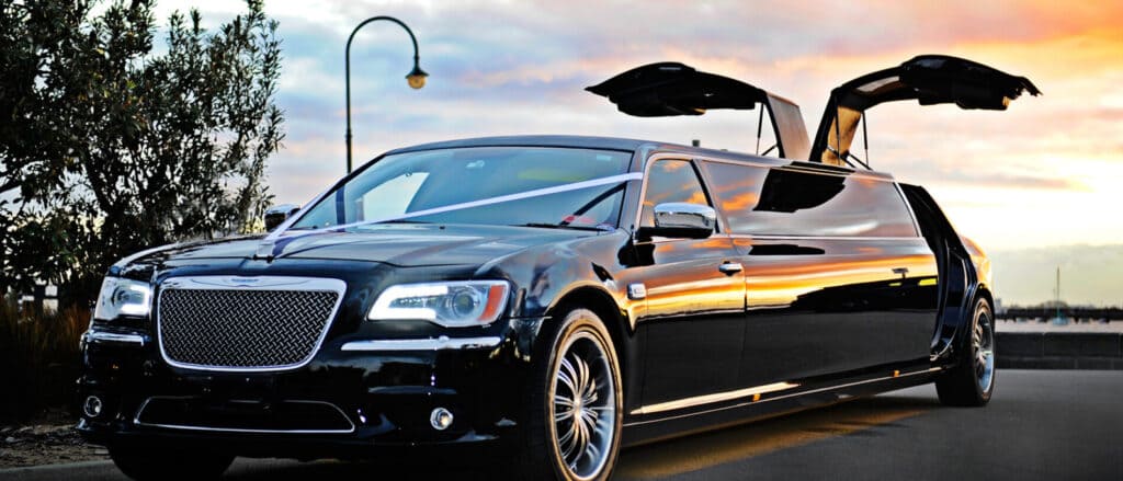 A black limo with an umbrella on top of it.