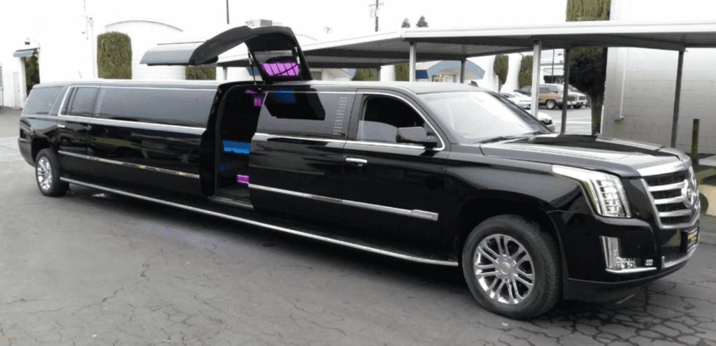 A black limo with open doors parked in the street.